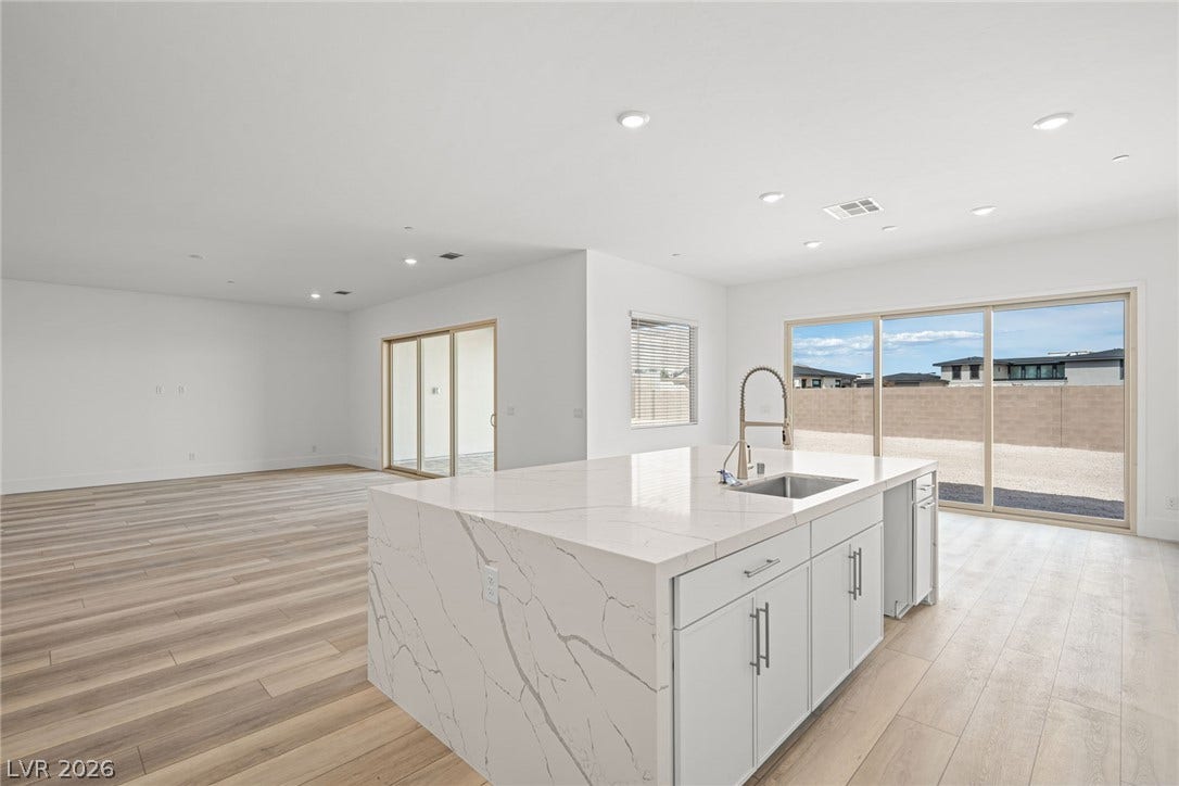 12428 Breezy Bluff Avenue, Las Vegas, NV 89138 Sliding glass doors open from the kitchen to reveal expansive outdoor views.