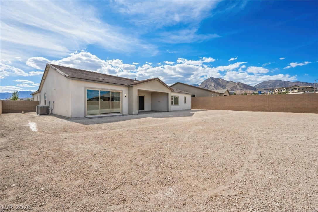 12428 Breezy Bluff Avenue, Las Vegas, NV 89138 A spacious rear yard framed by block fencing boasts scenic mountain views.