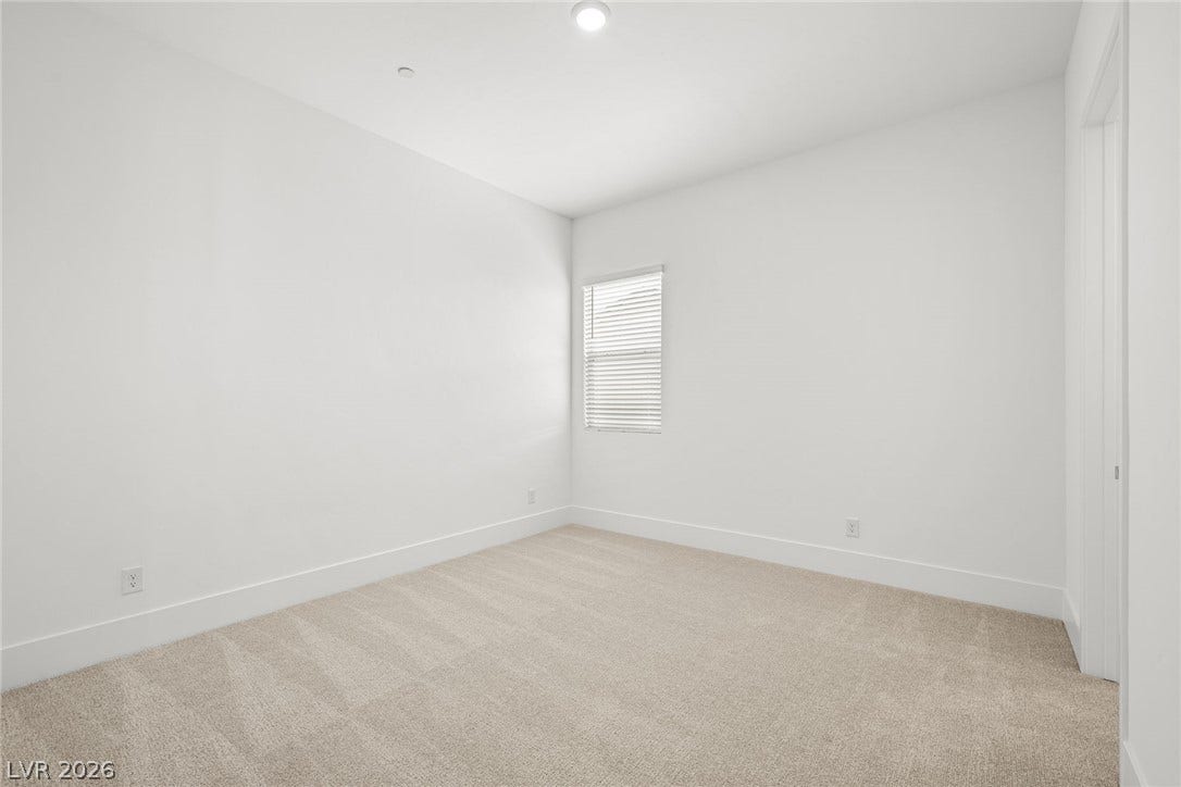 12428 Breezy Bluff Avenue, Las Vegas, NV 89138 Soft carpeting pairs with crisp walls in this versatile bedroom setting.