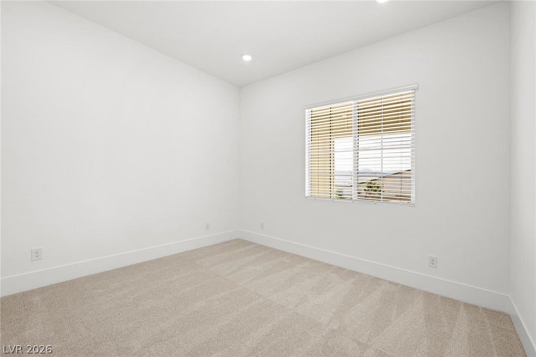 12428 Breezy Bluff Avenue, Las Vegas, NV 89138 Plush carpeting and recessed lighting create a comfortable, clean slate in this versatile room.