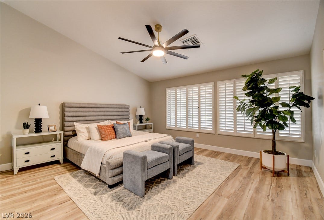 2837 Billy Casper Drive, Las Vegas, NV 89134 Vaulted ceilings with luxury vinyl floors elevate this comfortable primary suite.