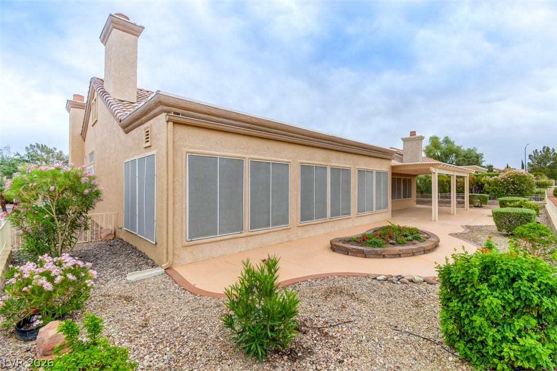 2837 Billy Casper Drive, Las Vegas, NV 89134 A spacious concrete patio stretches alongside the back of this stucco-finished home.