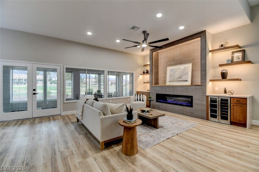 2837 Billy Casper Drive, Las Vegas, NV 89134 Fireplace with tv plug in, floating shelves with mood lighting, & wine bar & wine glass cabinet for entertaining.