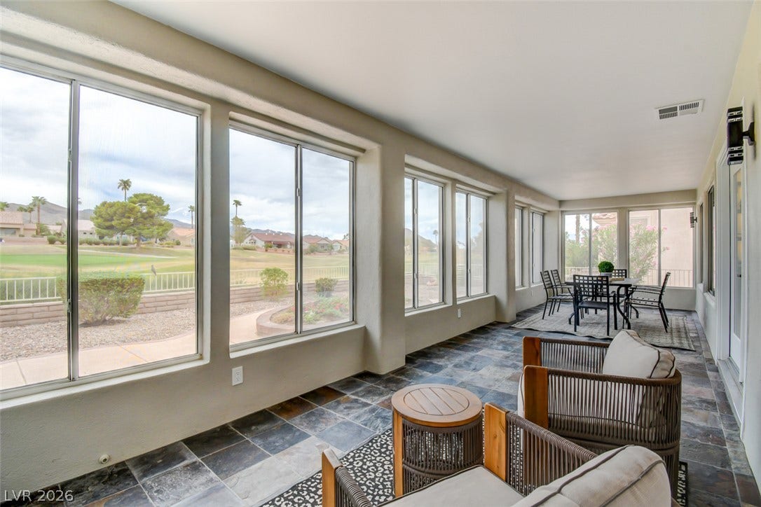 2837 Billy Casper Drive, Las Vegas, NV 89134 A long wall of windows brings natural light and outdoor views across the tiled sunroom.