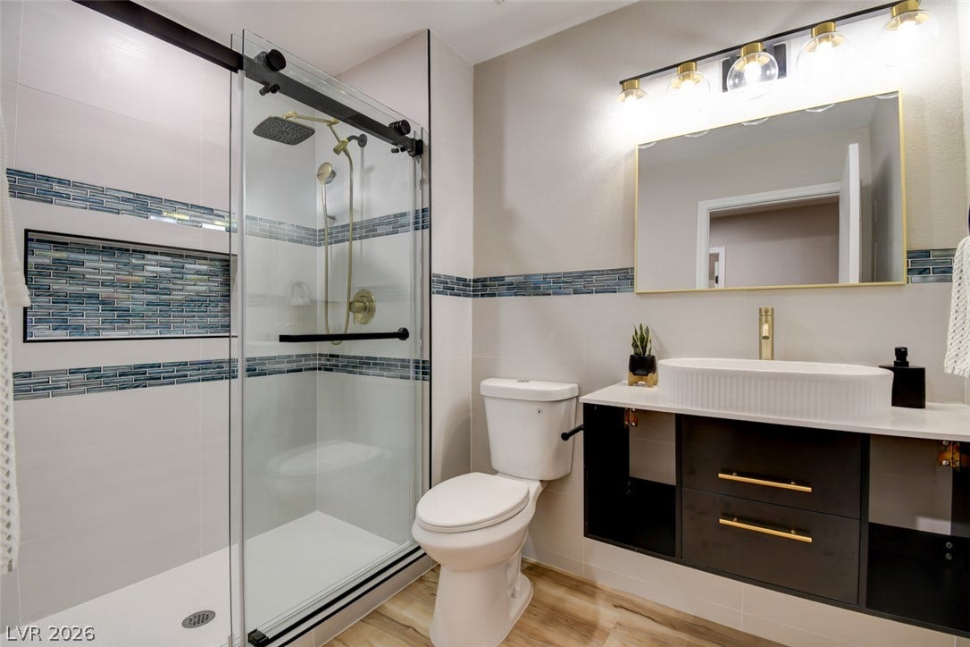 2837 Billy Casper Drive, Las Vegas, NV 89134 Modern finishes define this stylish bathroom complete with a glass-enclosed shower stall.