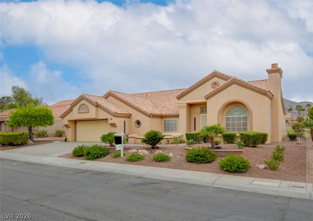2837 Billy Casper Drive, Las Vegas, NV 89134 Spanish tile roofing and pristine desert landscaping create classic curb appeal for this beautiful residence.