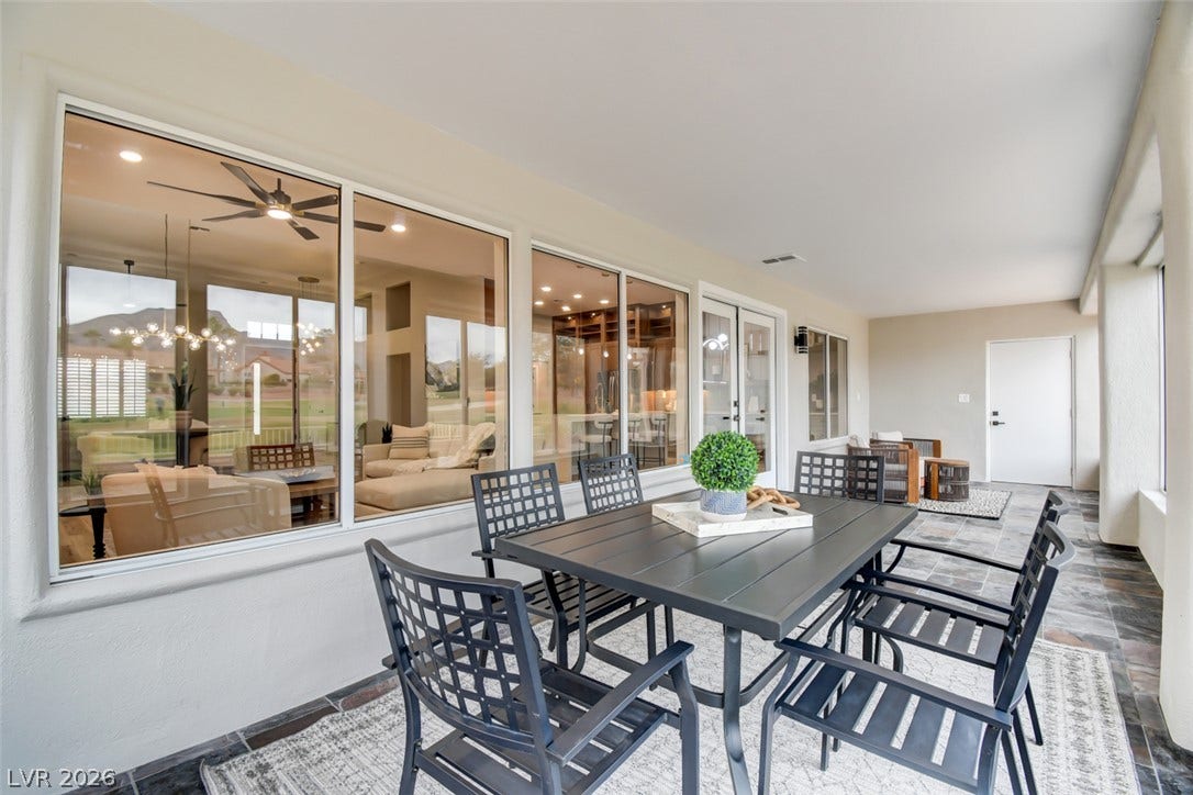 2837 Billy Casper Drive, Las Vegas, NV 89134 Sleek slate tile flooring grounds this covered outdoor living space with expansive views inside.