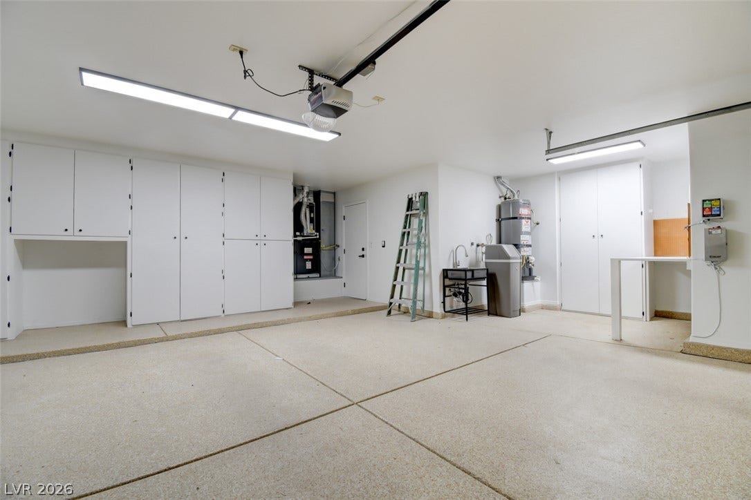 2837 Billy Casper Drive, Las Vegas, NV 89134 Finished garage with built-in storage cabinets, work bench, sink. Water filtration system and water conditioner for house.