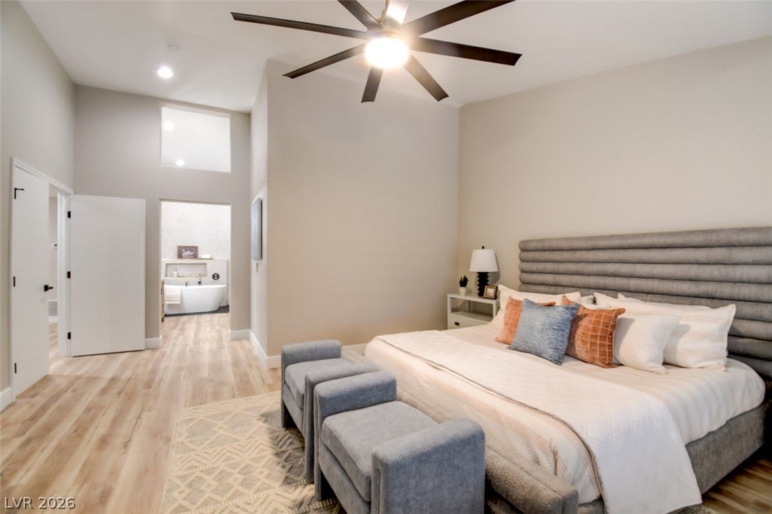 2837 Billy Casper Drive, Las Vegas, NV 89134 High ceilings with large fan & light define this tranquil bedroom suite with bathroom views.