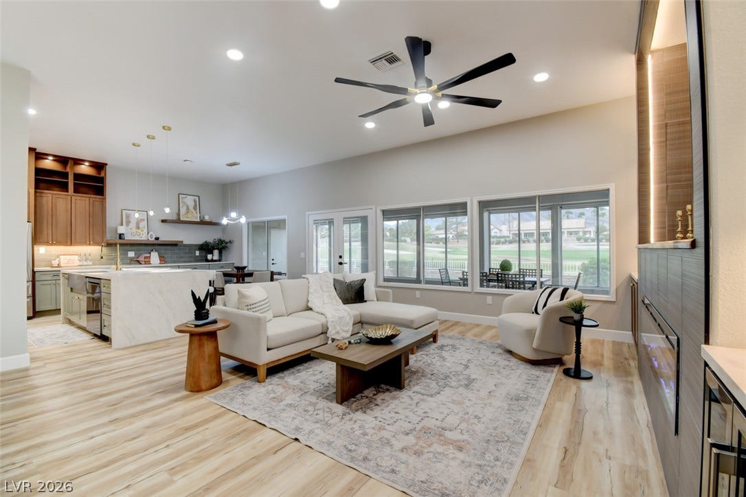 2837 Billy Casper Drive, Las Vegas, NV 89134 Electric fireplace, ceiling fan in spacious living area seamlessly connecting to the kitchen.