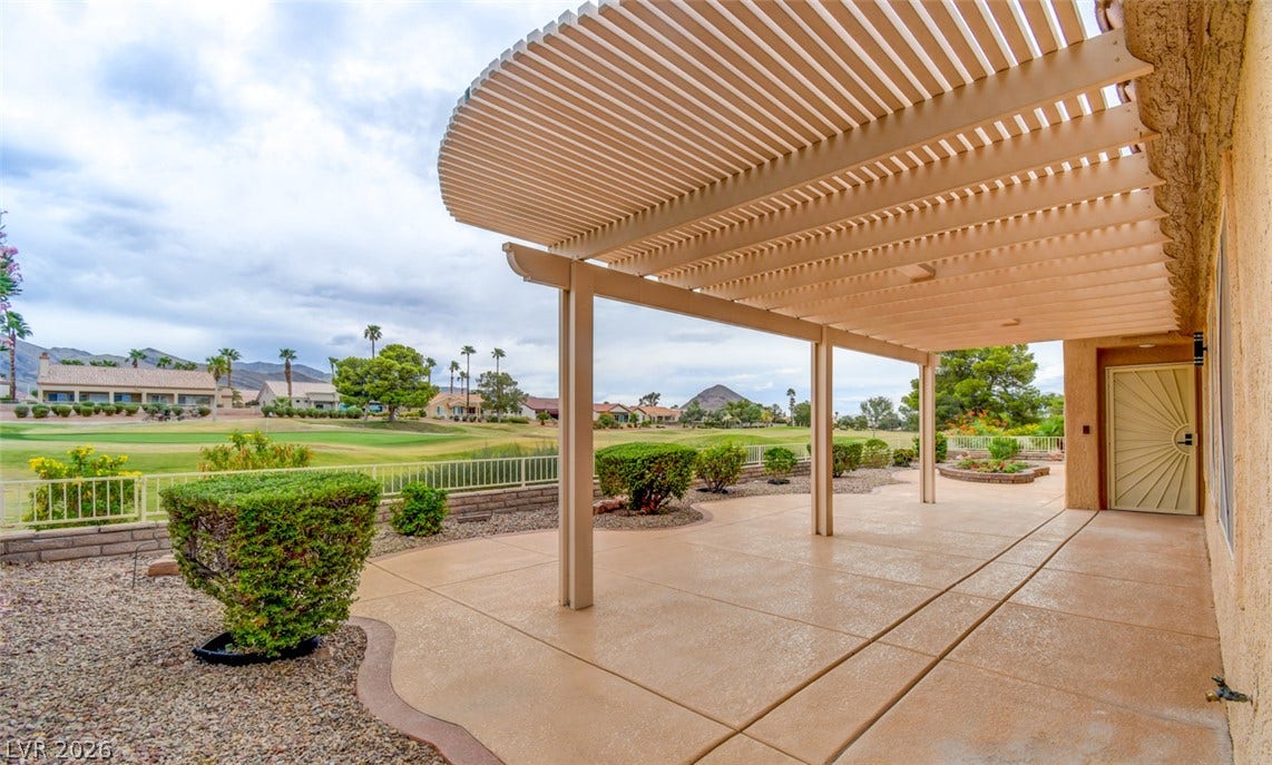 2837 Billy Casper Drive, Las Vegas, NV 89134 An expansive concrete patio sheltered by a curved pergola overlooks the rolling fairways.