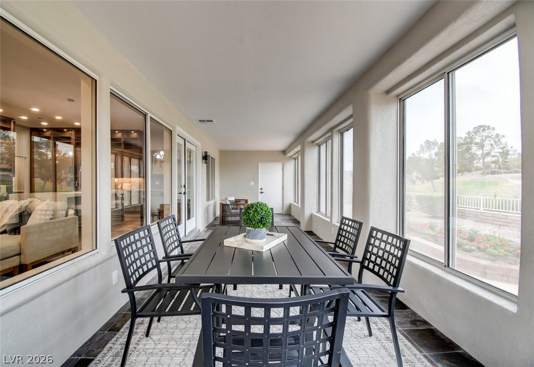 2837 Billy Casper Drive, Las Vegas, NV 89134 Numerous windows frame serene outdoor views in this elongated and airy sunroom.