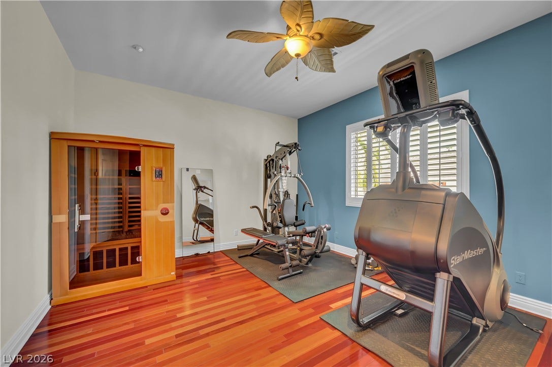 2030 Marina Bay Court, Las Vegas, NV 89117 Gleaming hardwood floors and classic window shutters elevate this dedicated home wellness space.
