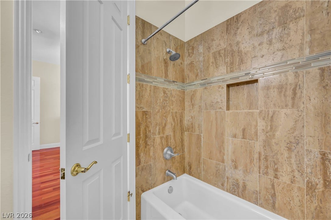 2030 Marina Bay Court, Las Vegas, NV 89117 Gleaming tile surrounds the built-in bathtub, offering an inviting and functional space.
