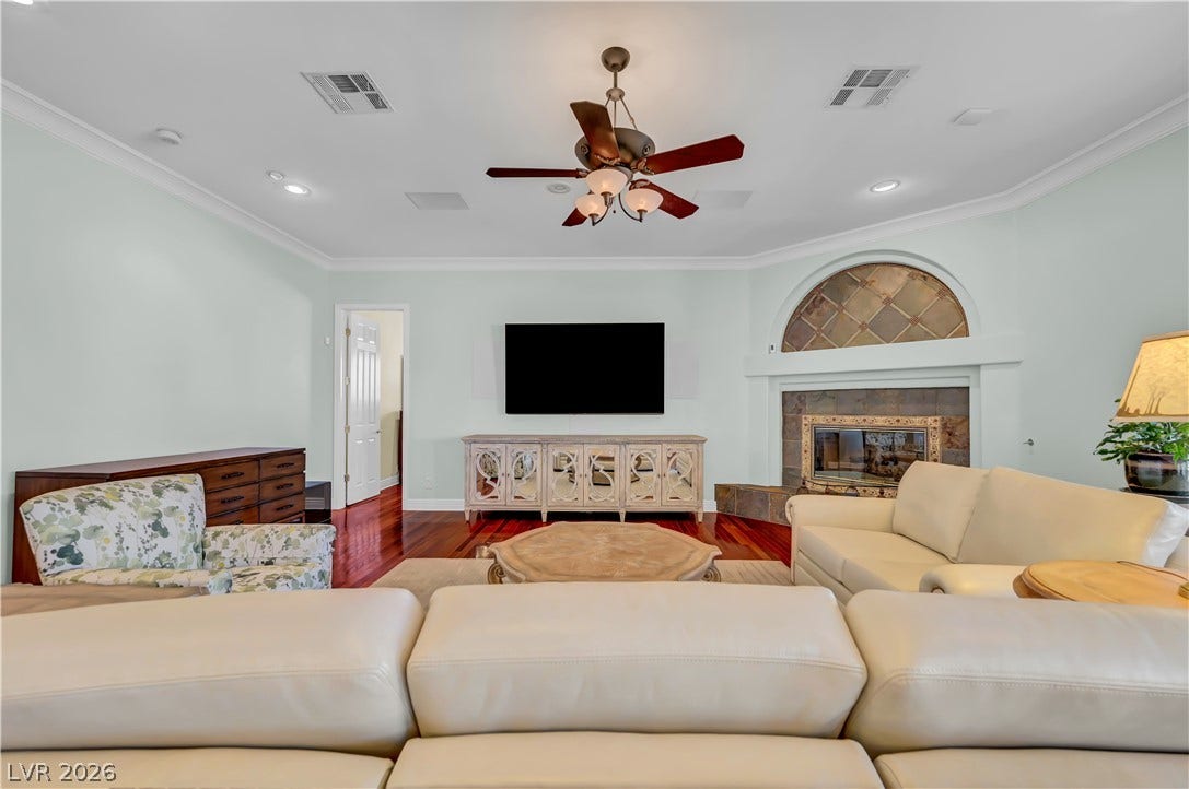 2030 Marina Bay Court, Las Vegas, NV 89117 Rich hardwood floors and a tiled corner fireplace define this comfortable living space.