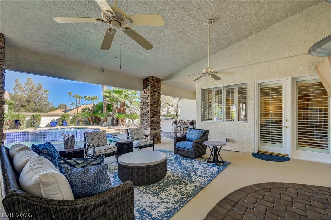 2030 Marina Bay Court, Las Vegas, NV 89117 A spacious covered patio overlooks the sparkling backyard pool and manicured palm trees.