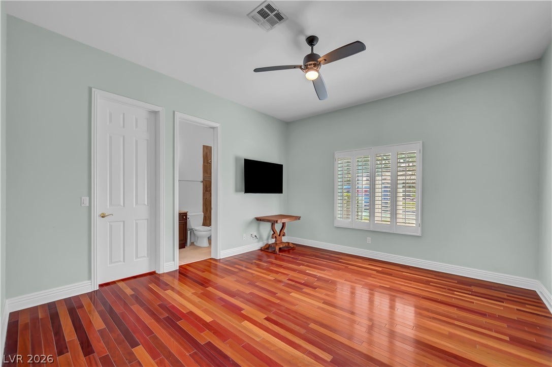 2030 Marina Bay Court, Las Vegas, NV 89117 Gleaming hardwood floors and classic plantation shutters define this versatile bedroom space.