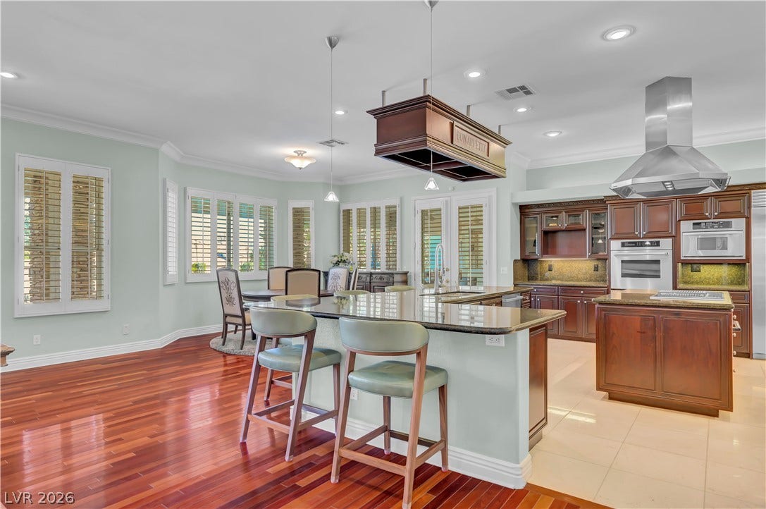 2030 Marina Bay Court, Las Vegas, NV 89117 Rich hardwood floors complement the gourmet kitchen and adjoining light-filled dining space.