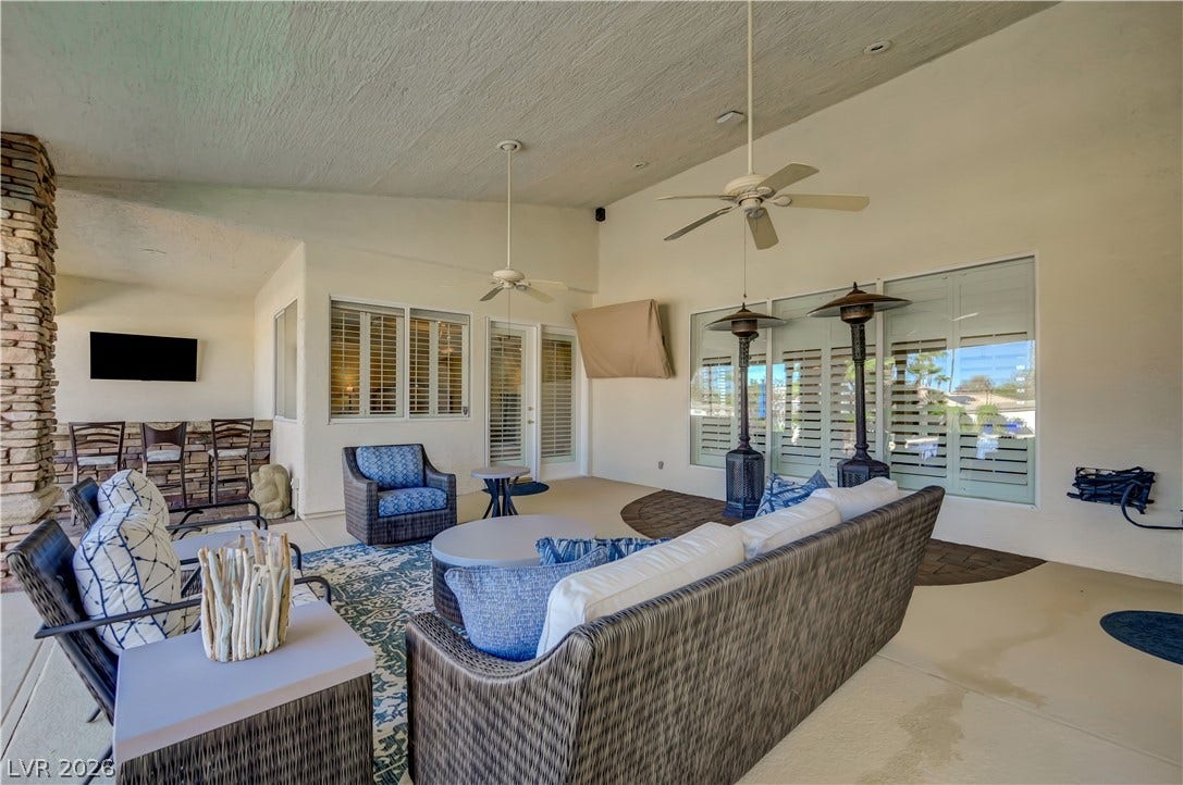 2030 Marina Bay Court, Las Vegas, NV 89117 An inviting covered patio features a textured ceiling, durable concrete flooring, and rustic stone accents.