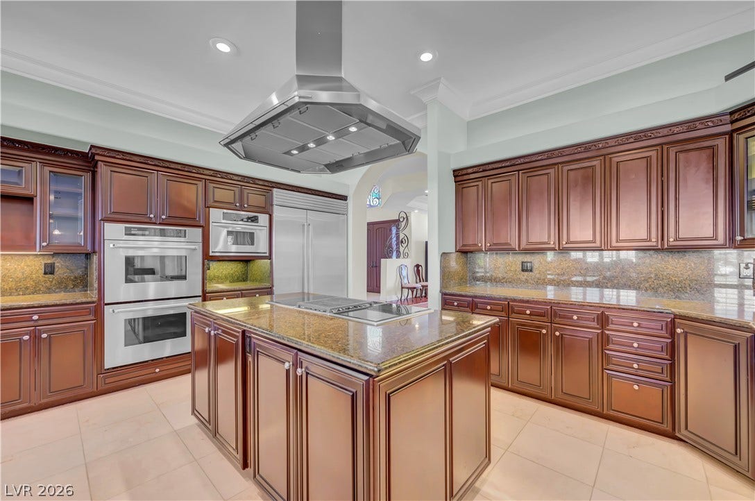 2030 Marina Bay Court, Las Vegas, NV 89117 Rich wood cabinetry and stone countertops anchor this gourmet kitchen featuring a central island.