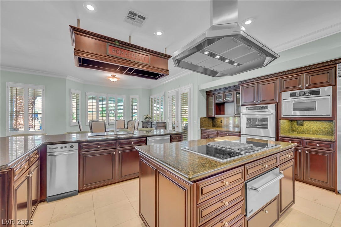 2030 Marina Bay Court, Las Vegas, NV 89117 Rich wood cabinetry paired with stone countertops defines this gourmet kitchen centered around dual islands.