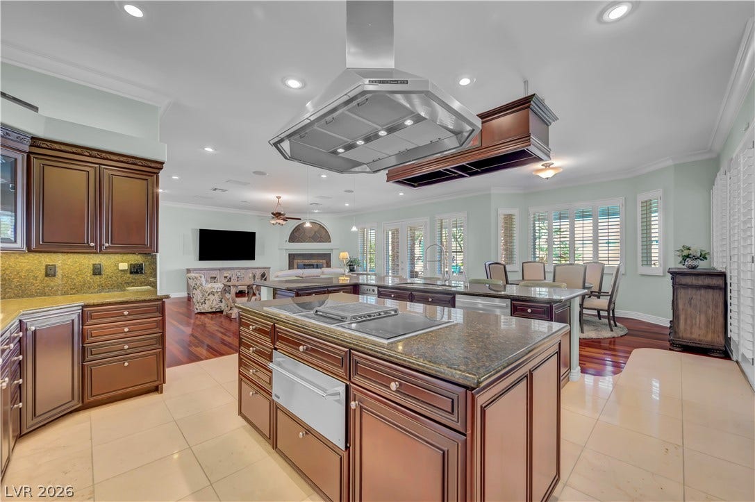 2030 Marina Bay Court, Las Vegas, NV 89117 Rich wood cabinetry and expansive granite islands anchor this open-concept culinary space.