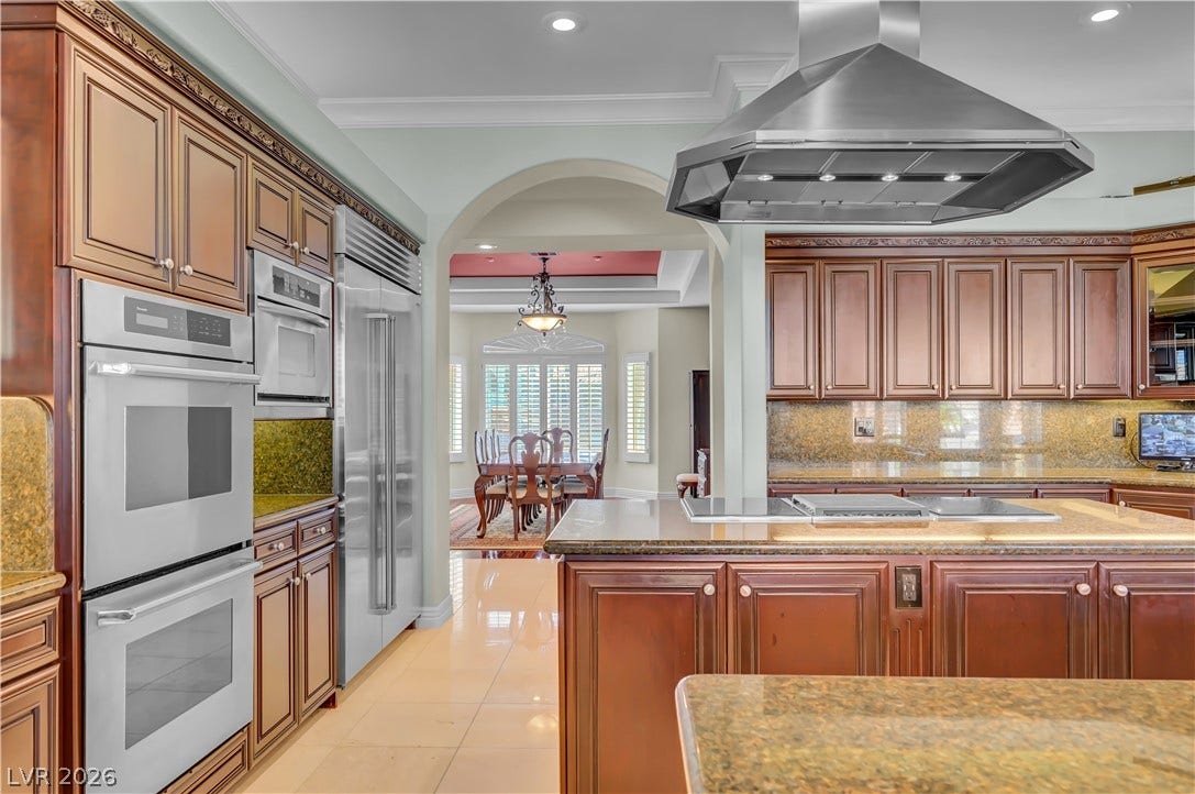 2030 Marina Bay Court, Las Vegas, NV 89117 Granite countertops and rich wood cabinetry define this gourmet kitchen space with integrated appliances.
