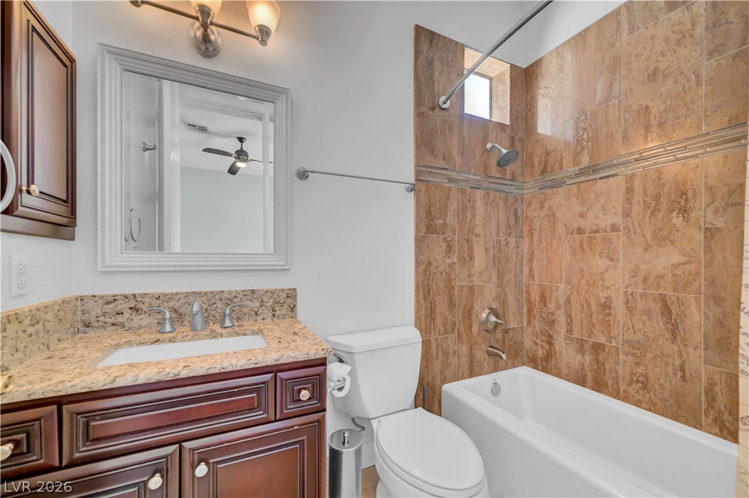 2030 Marina Bay Court, Las Vegas, NV 89117 Polished granite countertops pair with classic wood cabinetry and elegant tile tub surrounds.
