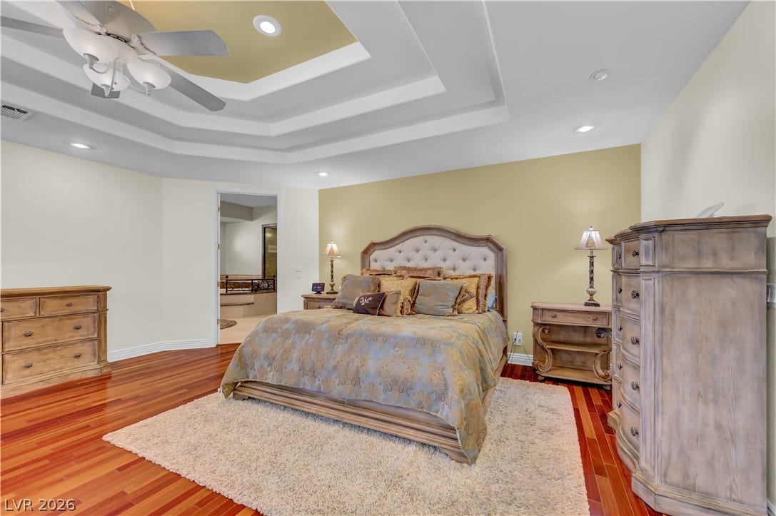 2030 Marina Bay Court, Las Vegas, NV 89117 Rich hardwood floors and an elegant tray ceiling define this peaceful bedroom retreat.