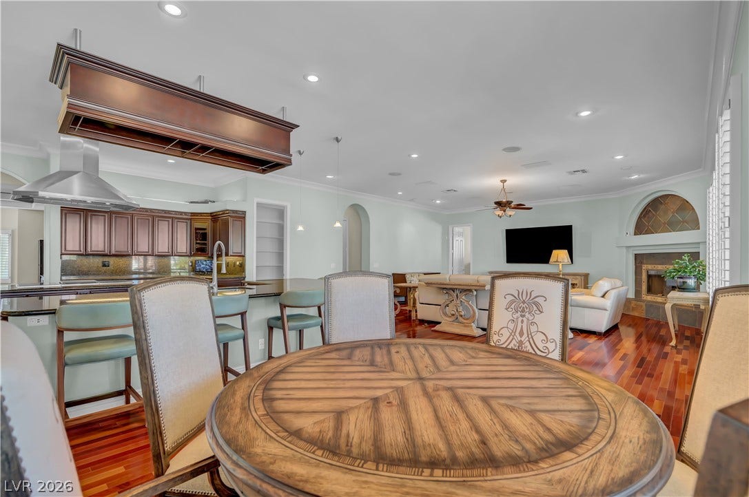 2030 Marina Bay Court, Las Vegas, NV 89117 Rich hardwood flooring anchors the seamless transition between the dining area and kitchen.