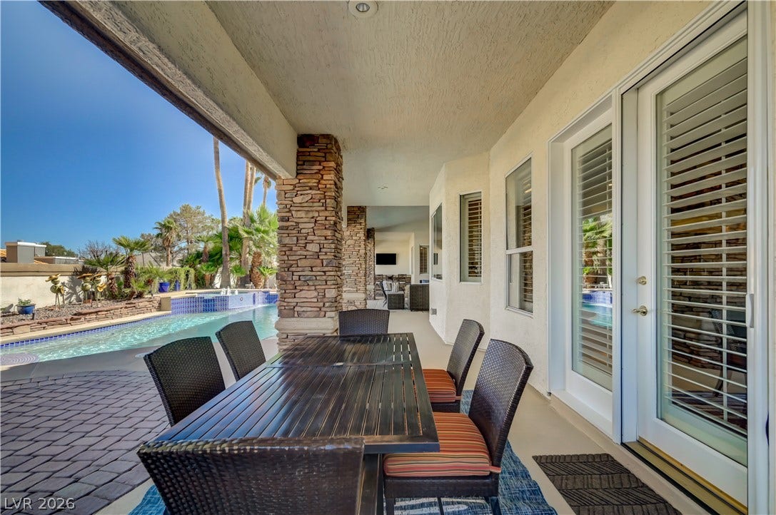 2030 Marina Bay Court, Las Vegas, NV 89117 Shaded outdoor spaces connect seamlessly with the poolside patio through glass sliding doors.