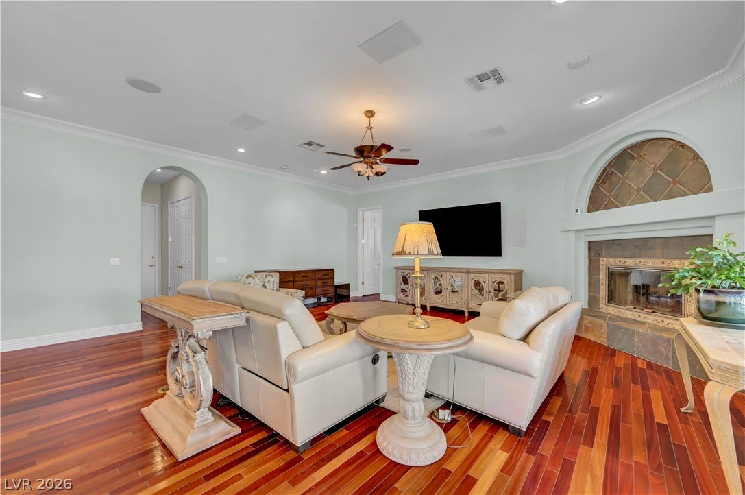 2030 Marina Bay Court, Las Vegas, NV 89117 Rich hardwood floors and a tiled fireplace bring warmth to this spacious living area.