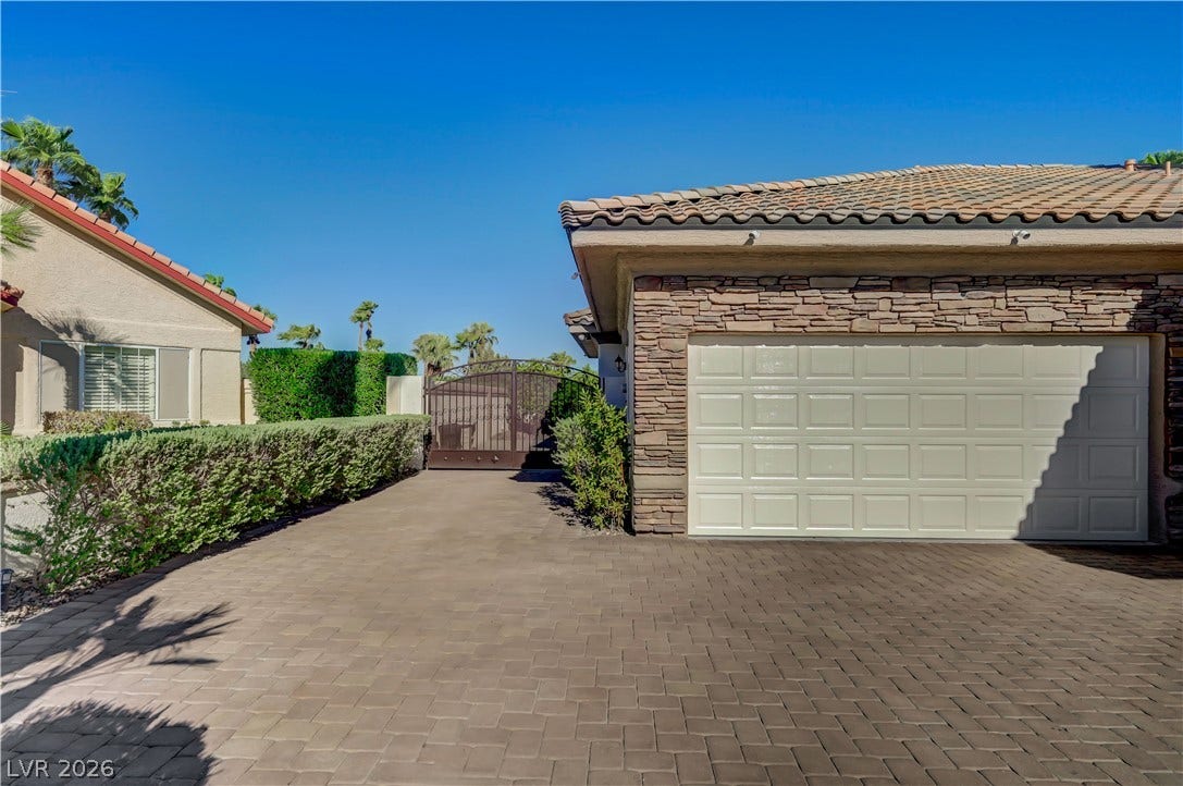 2030 Marina Bay Court, Las Vegas, NV 89117 A spacious interlocking paver driveway leads to a gated side yard and double garage.