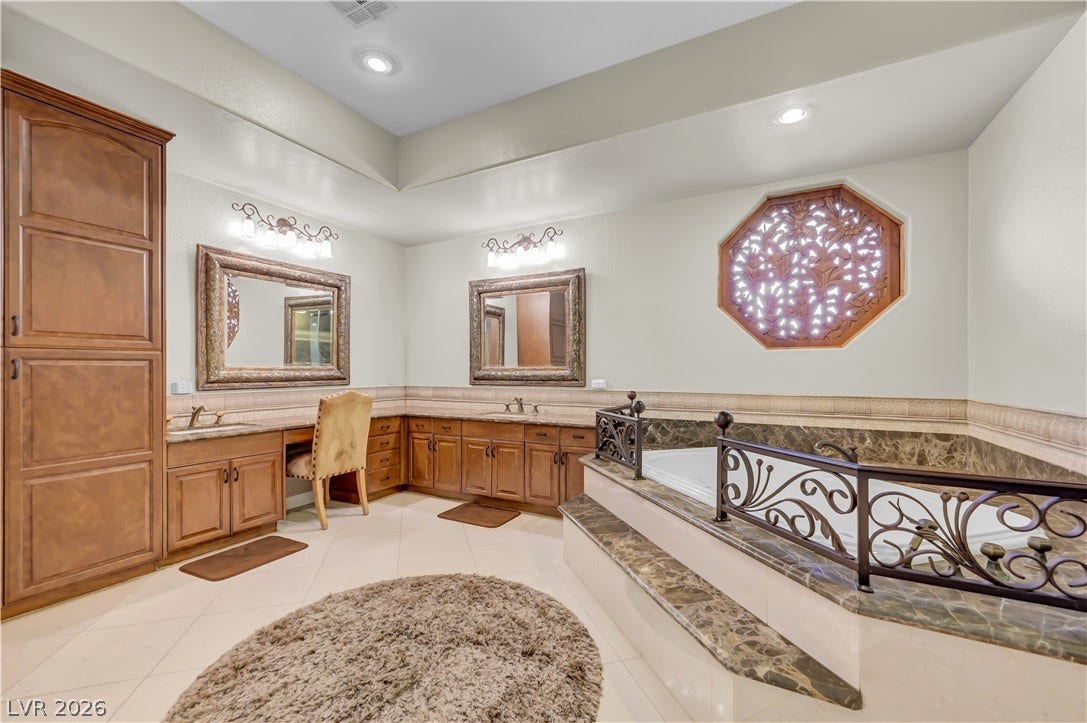 2030 Marina Bay Court, Las Vegas, NV 89117 Rich wood cabinetry and a deep soaking tub create a luxurious bathroom retreat.