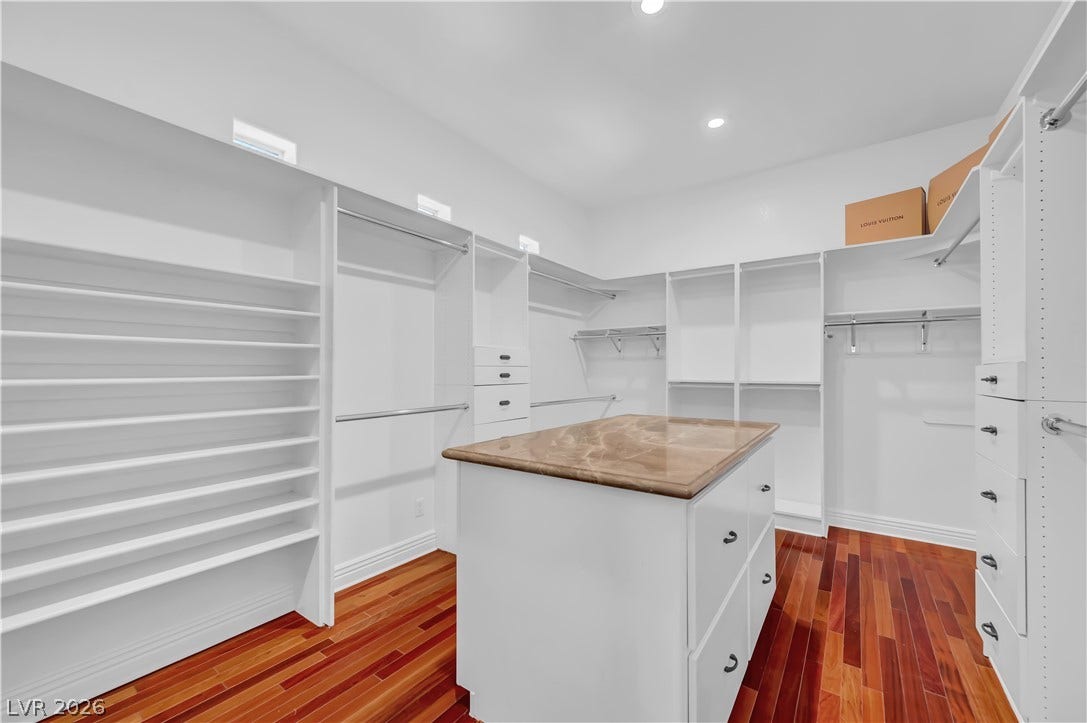 2030 Marina Bay Court, Las Vegas, NV 89117 Rich hardwood flooring pairs with custom built-in shelving and a stone-topped center island.