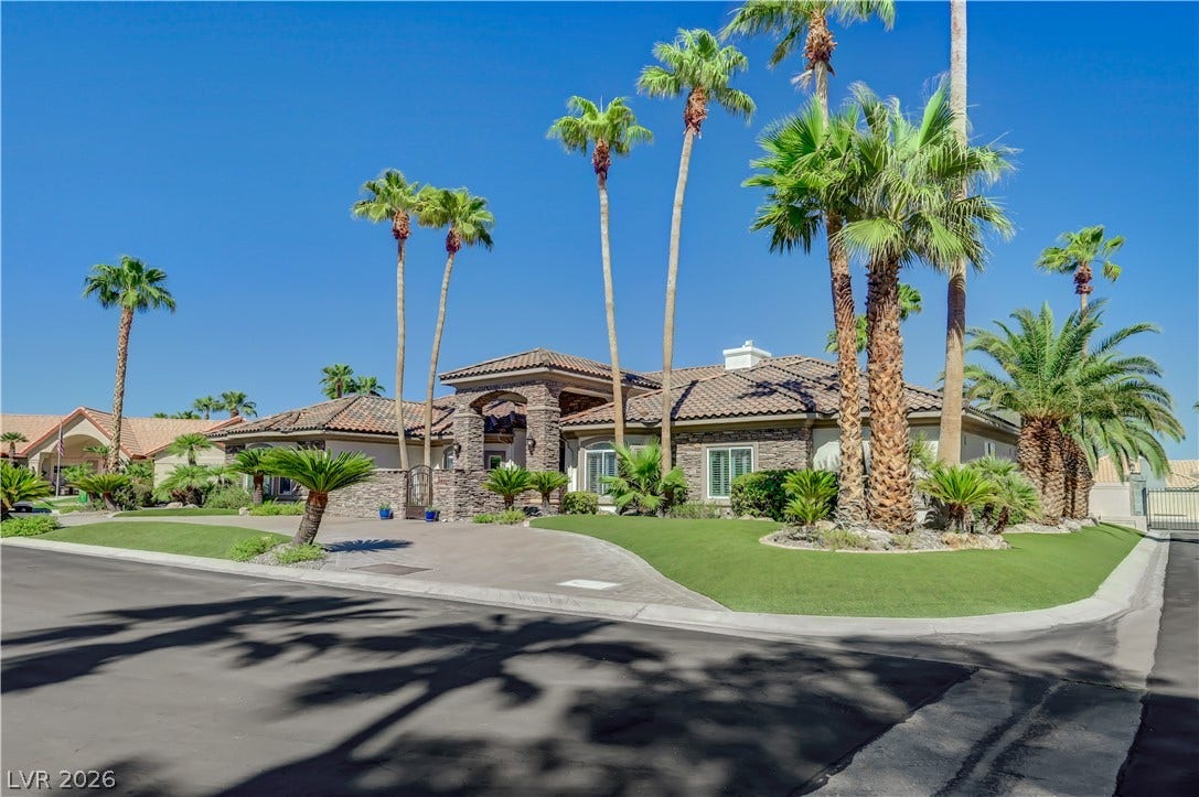 2030 Marina Bay Court, Las Vegas, NV 89117 Palm trees frame a stone-accented exterior with classic Spanish tile roofing.