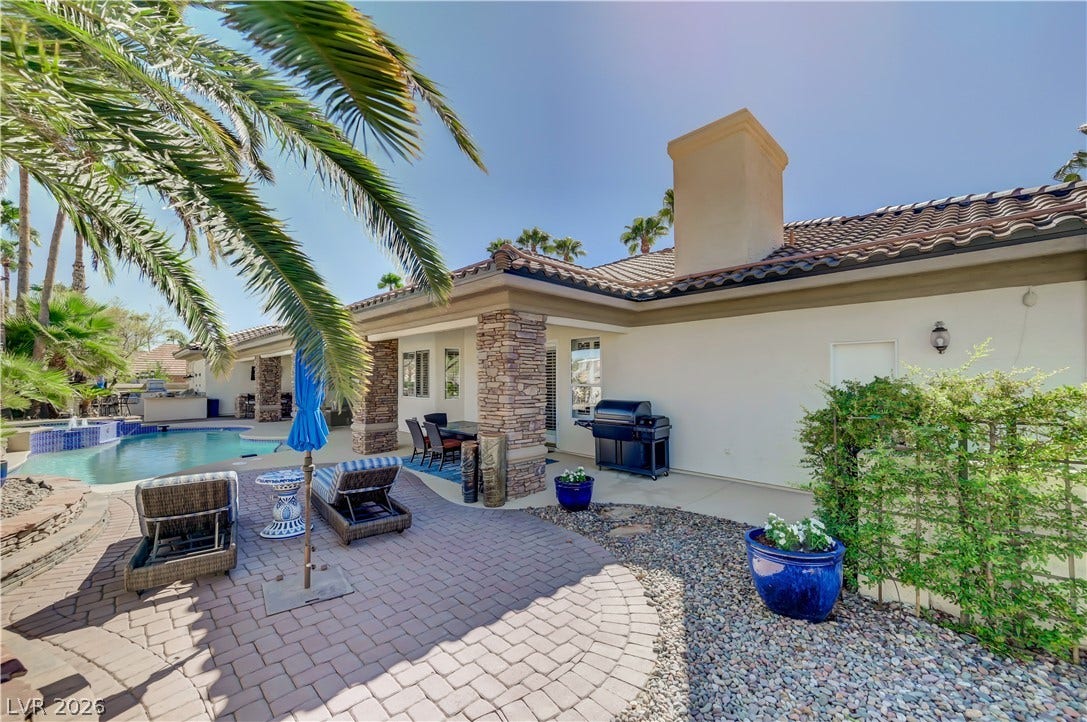 2030 Marina Bay Court, Las Vegas, NV 89117 An inviting backyard patio features stone pillars, durable pavers, and a tiled pool.