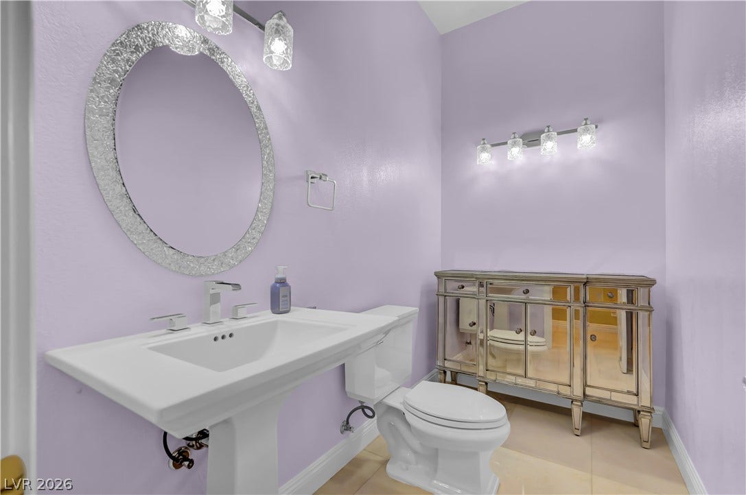 2030 Marina Bay Court, Las Vegas, NV 89117 An elegant pedestal sink and ornate mirrors define this stylish powder room.