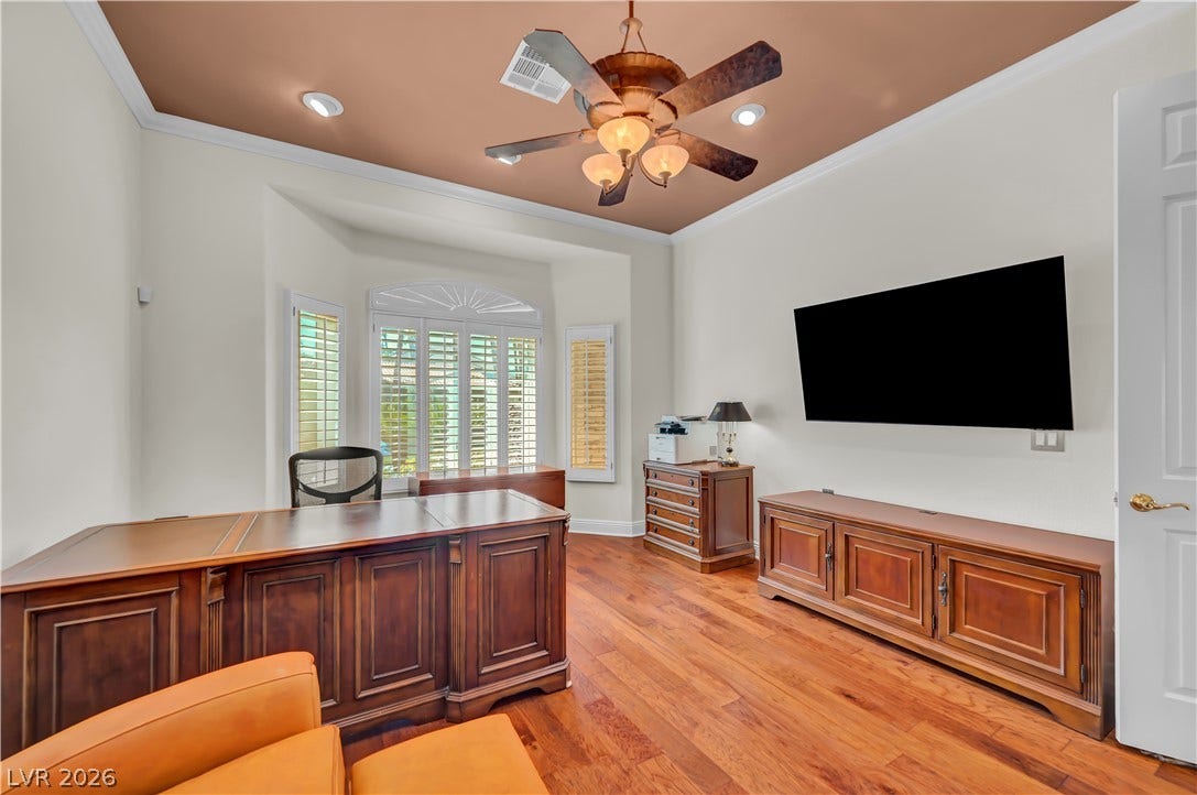2030 Marina Bay Court, Las Vegas, NV 89117 Rich hardwood floors and an elegant tray ceiling define this private home workspace.