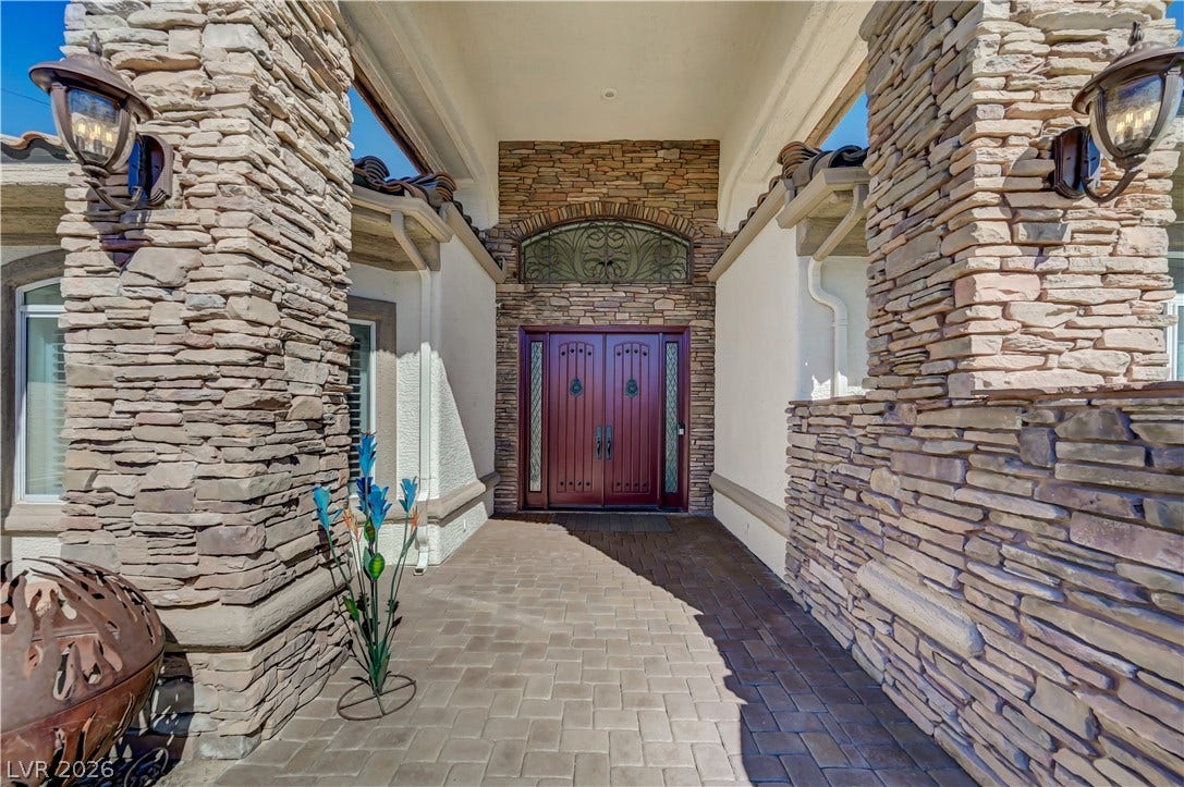 2030 Marina Bay Court, Las Vegas, NV 89117 Stone pillars frame the welcoming covered entry path leading to grand double doors.