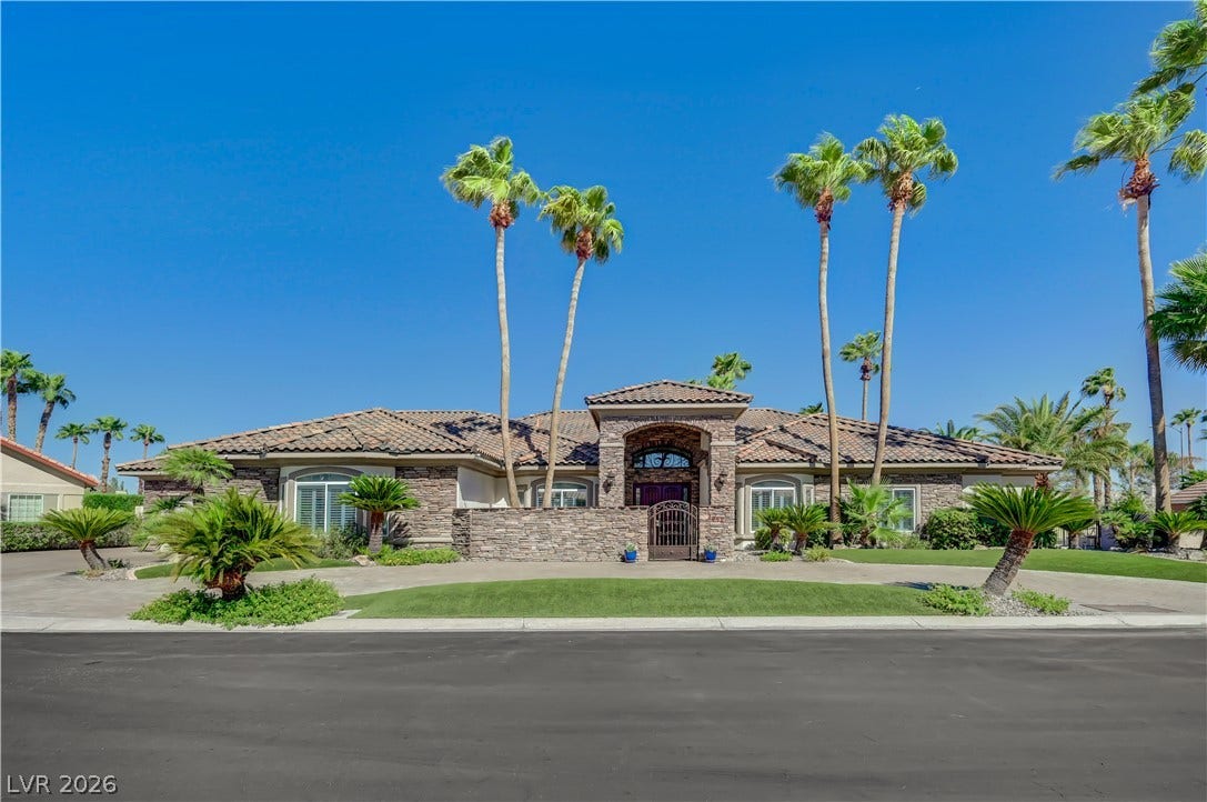 2030 Marina Bay Court, Las Vegas, NV 89117 Palm trees frame the stone-accented facade of this elegant single-story desert home.
