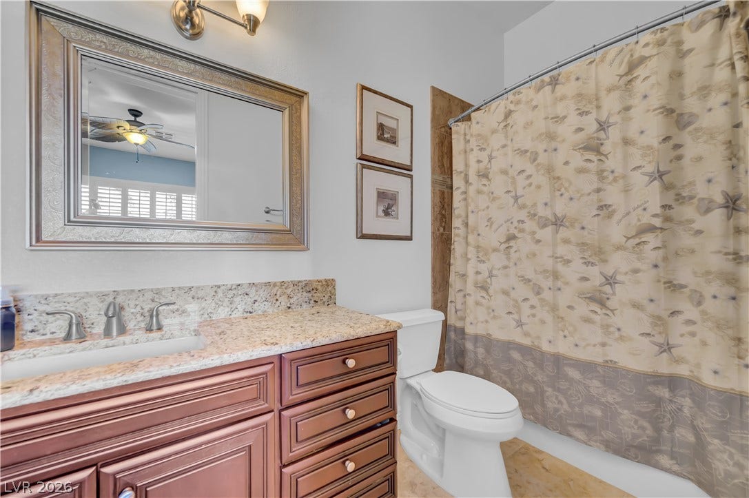 2030 Marina Bay Court, Las Vegas, NV 89117 Rich wood cabinetry is paired with premium granite countertops in this well-appointed bathroom.