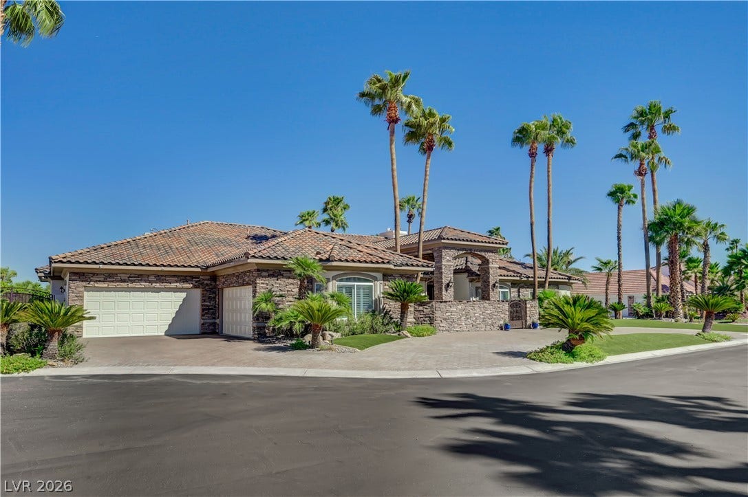 2030 Marina Bay Court, Las Vegas, NV 89117 Palm trees and stone accents frame this desert estate featuring a spacious three-car garage.