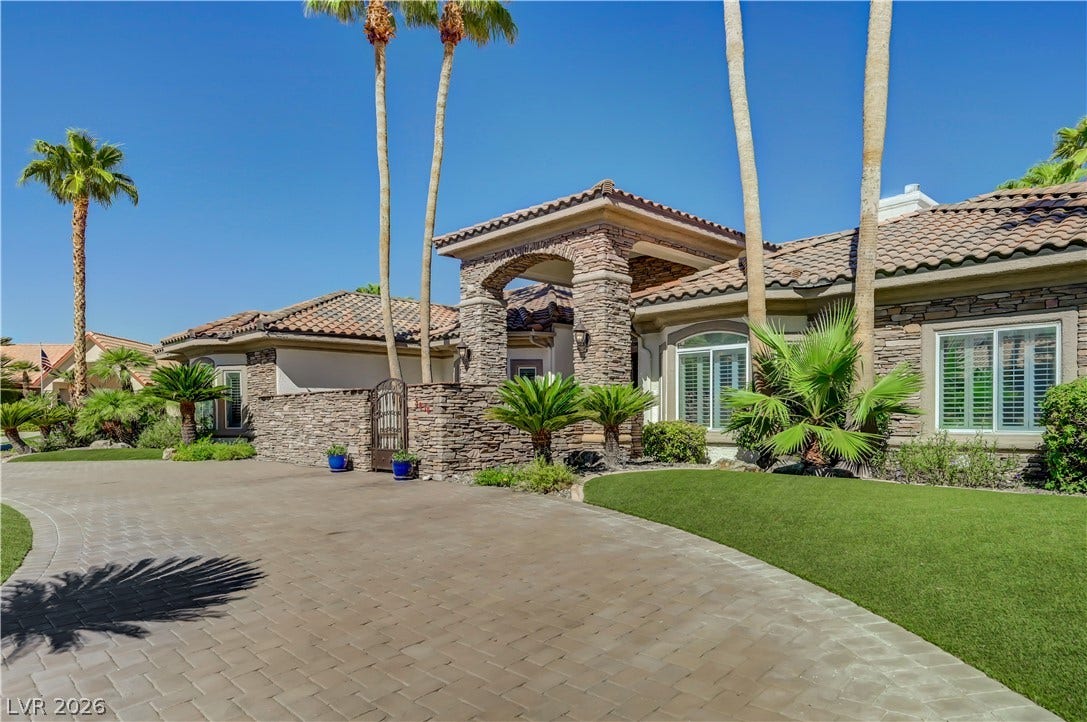 2030 Marina Bay Court, Las Vegas, NV 89117 Grand stone archways and manicured lawns frame this desert estate's impressive entrance.
