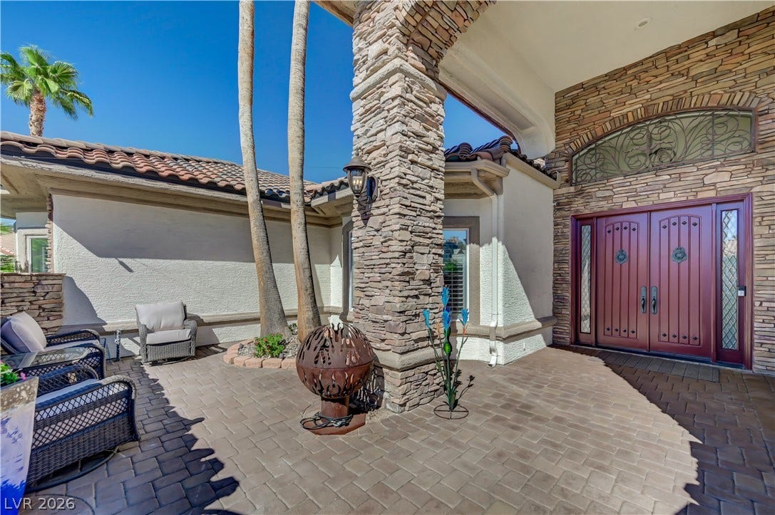 2030 Marina Bay Court, Las Vegas, NV 89117 An inviting stone-clad entry features beautiful paver tilework under a sheltered portico.