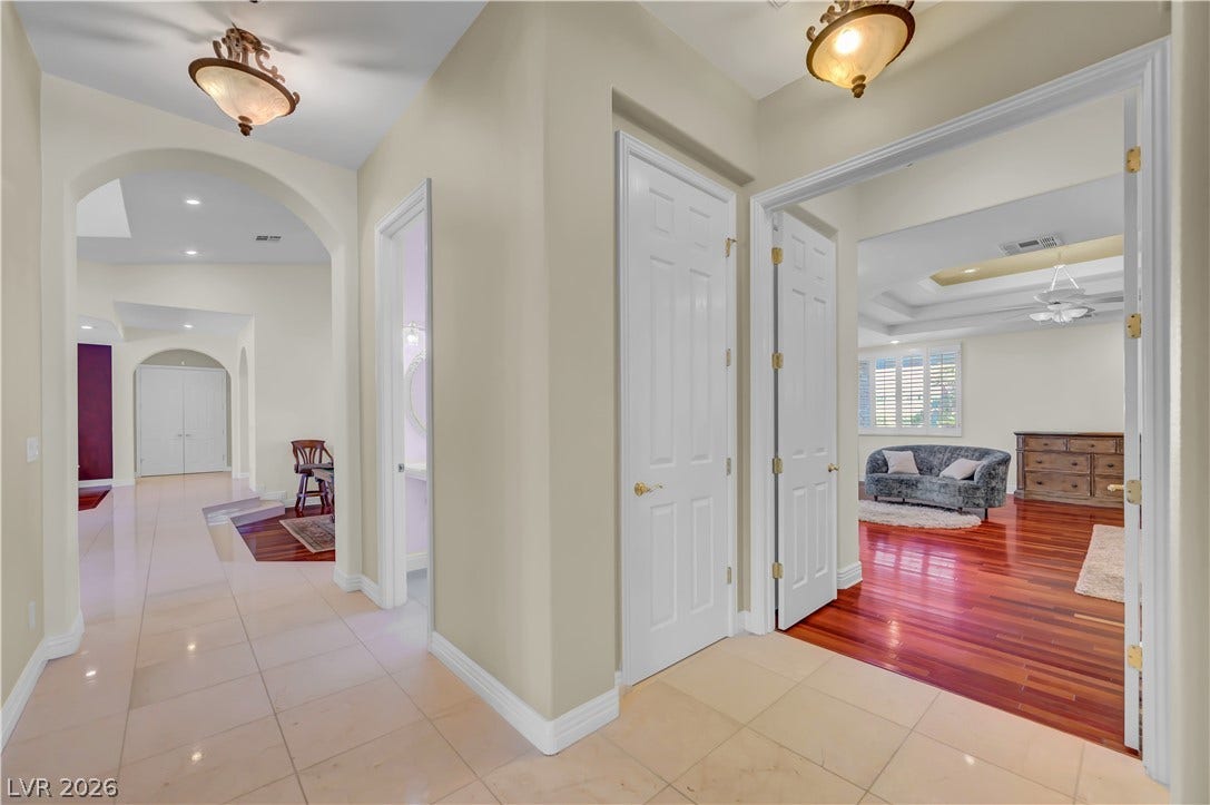 2030 Marina Bay Court, Las Vegas, NV 89117 Gleaming tile floors transition to warm wood tones through classic arched and paneled doorways.