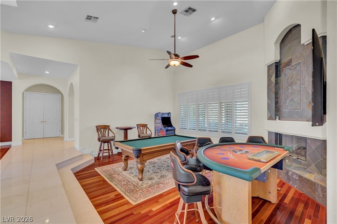 2030 Marina Bay Court, Las Vegas, NV 89117 Warm hardwood flooring and a tiled fireplace elevate this versatile recreation space.