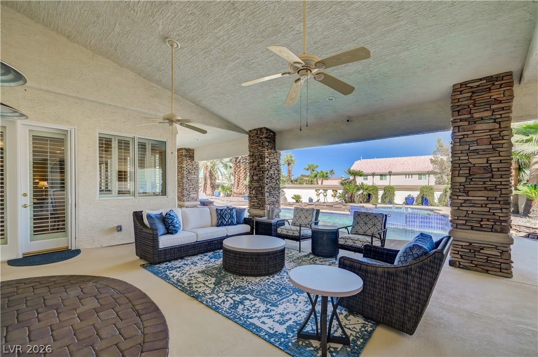 2030 Marina Bay Court, Las Vegas, NV 89117 An inviting covered patio showcases rustic stone pillars alongside a view of the pool.