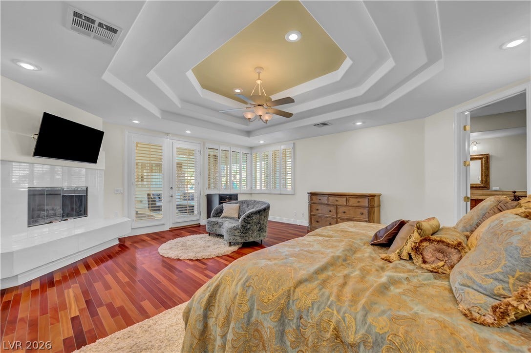 2030 Marina Bay Court, Las Vegas, NV 89117 Rich hardwood floors and an ornate tray ceiling define this spacious bedroom suite.