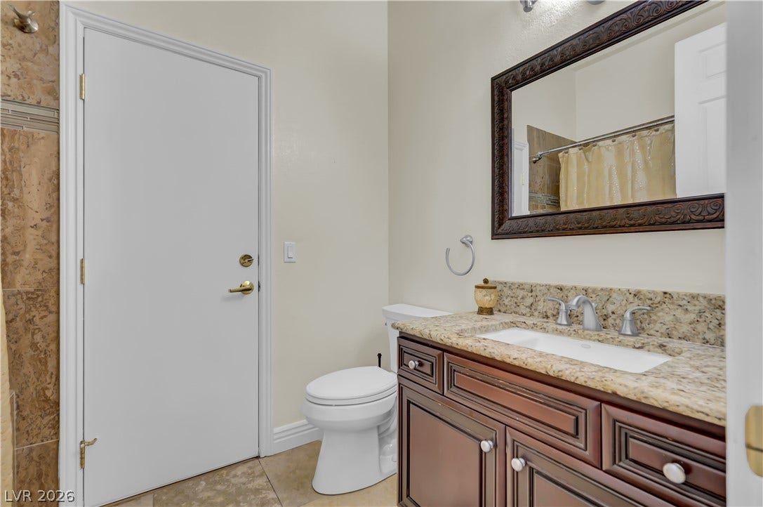 2030 Marina Bay Court, Las Vegas, NV 89117 Rich wood cabinetry and polished granite counters bring classical elegance to this bath.